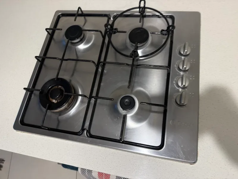 Polished stone kitchen island and stainless steel sink cleaned in Maroochydore QLD