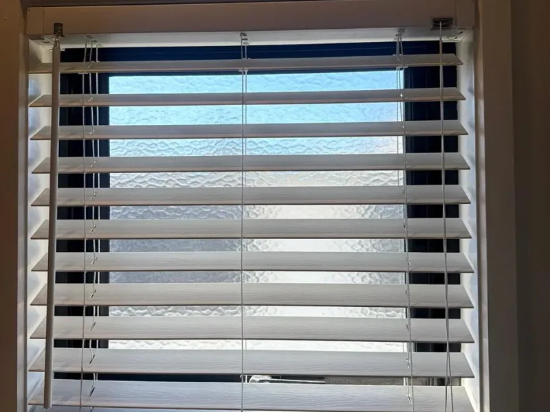 Sanitized glass shower screen and descaled ceramic wall tiles free of soap scum